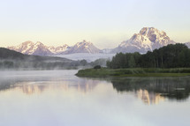 Fog rolls in on the snake river at Oxbow Bend at sunrise. Oxbow Bend is located in Grand teton National Park