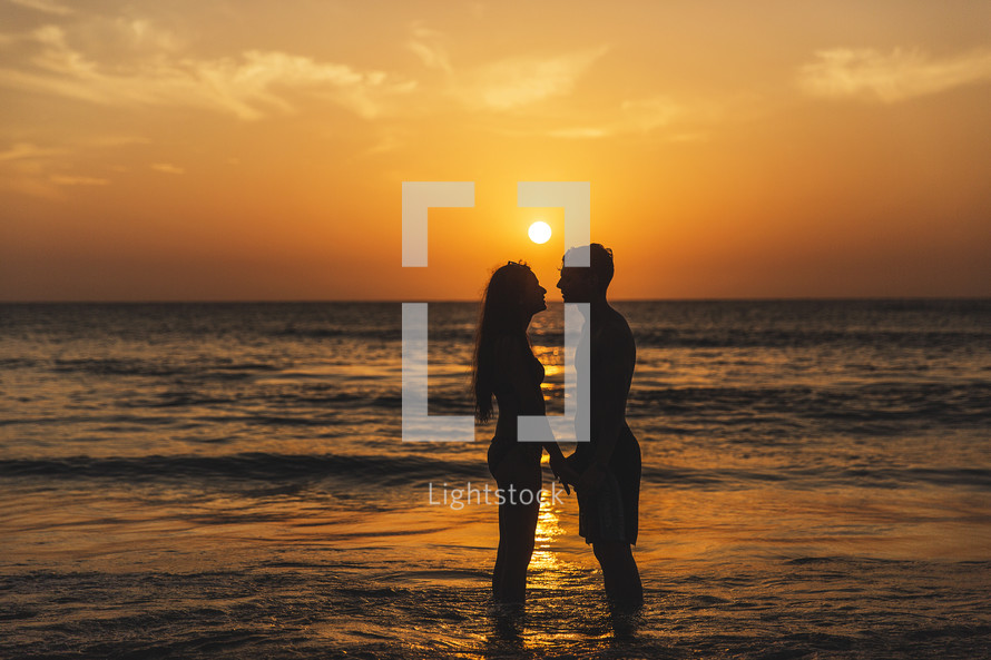 couple on the beach at sunset 