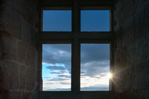 Sunlight shining through a cross shaped window. 
