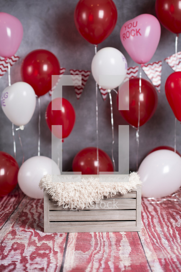 crate and red balloons 
