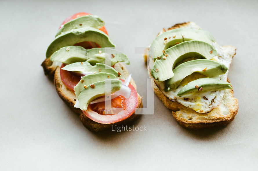 sliced tomato and avocado on a sandwich 