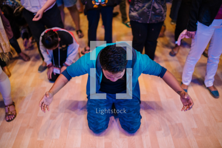 kneeling on the floor during a worship service 