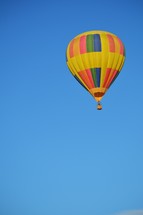 rainbow hot air balloon against blue sky 