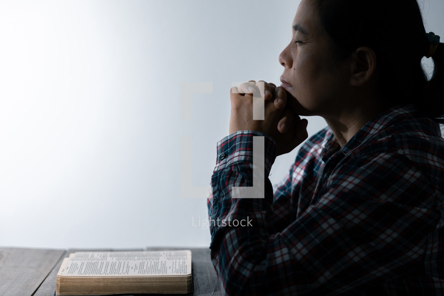 White background and woman praying with Bible
