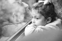 child looking out a train window 