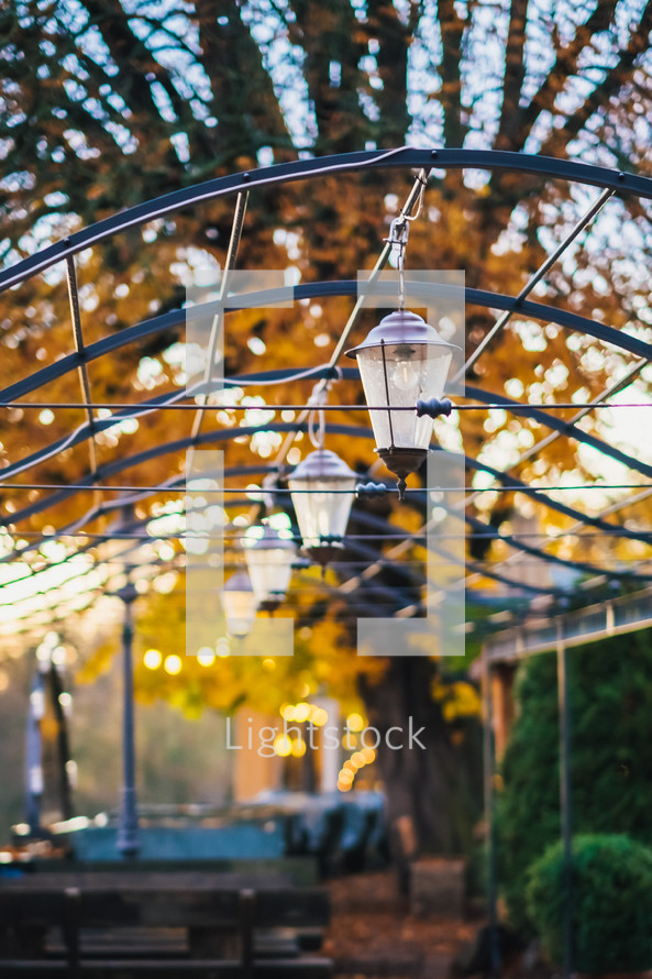 lanterns hanging over picnic tables 