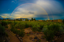 double rainbow over desert landscape 