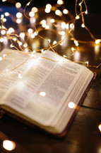 fairy lights on the pages of a Bible