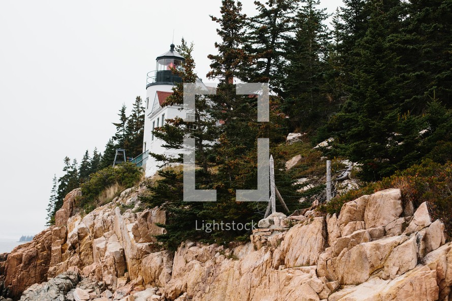 lighthouse on a rugged rocky cliff 