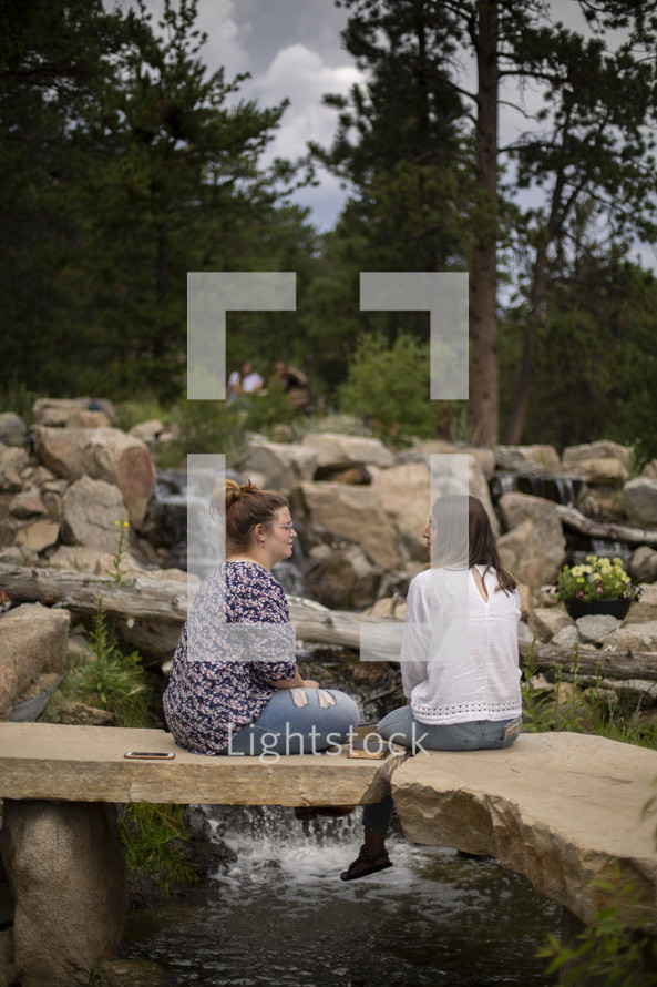 young women discussing scripture outdoors 