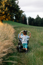 Boy is pushing a buggy