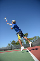 man playing tennis on the tennis courts 