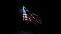 Waving American flag at night. 