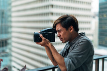 A man looks through a video camera.