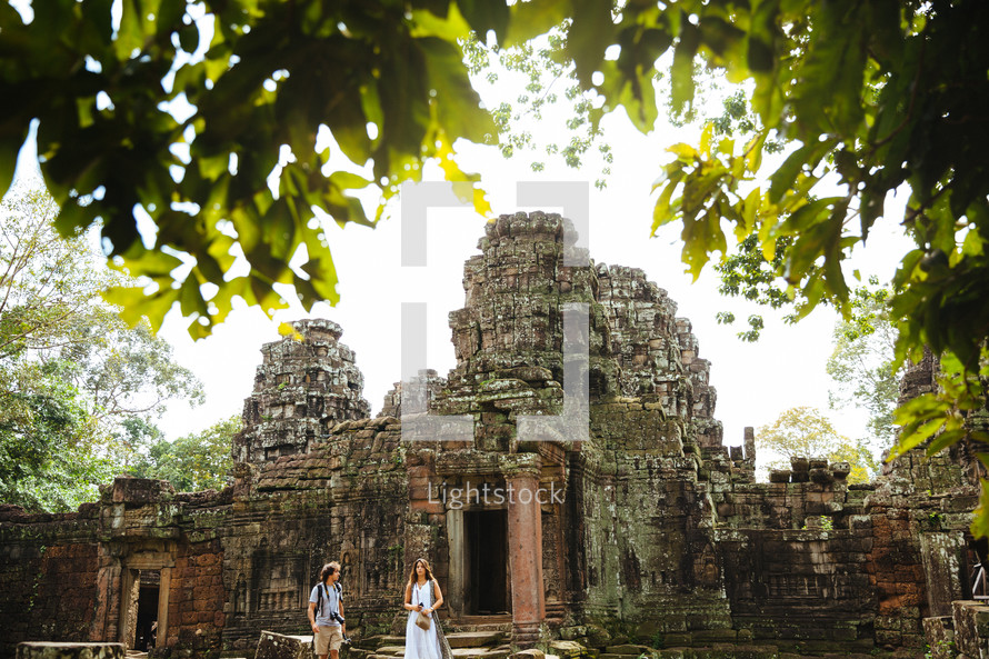 tourists in front of ruins in Angkor Wat 