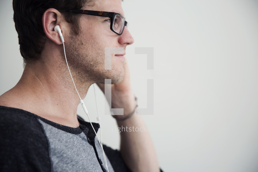 A man listening with ear phones.