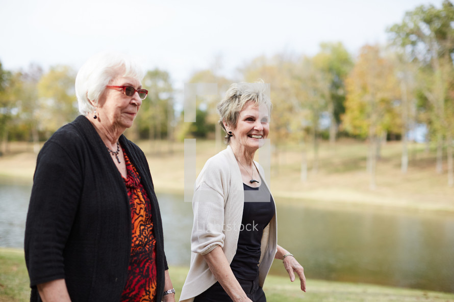 senior women walking by a pond 