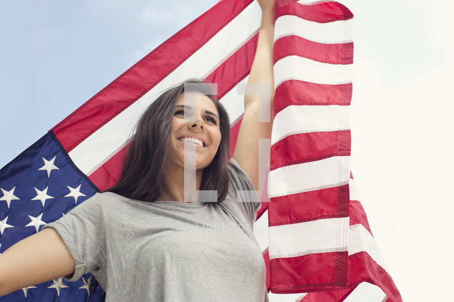young woman holding an American flag