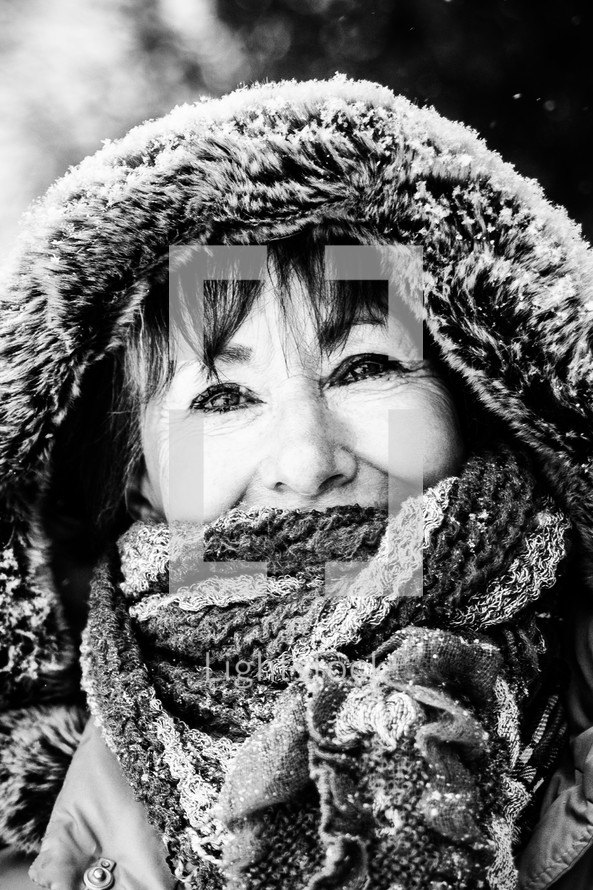 Smiling woman in winter coat with hood.