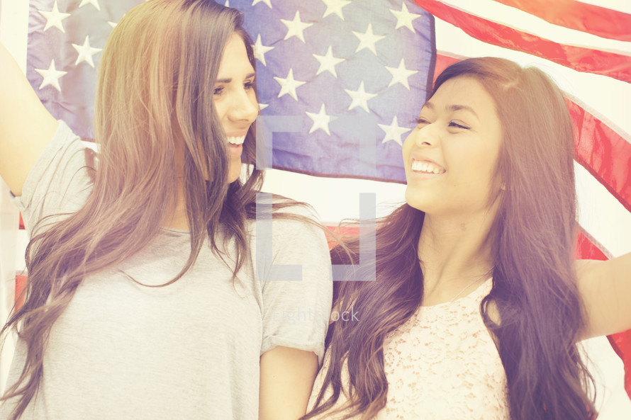 friendship between young women under an American flag
