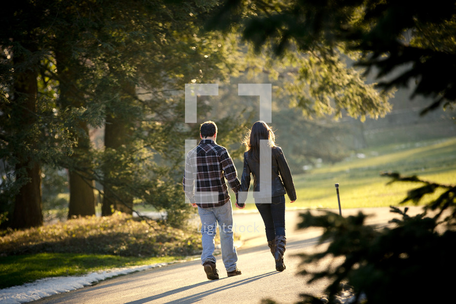 a couple walking holding hands outdoors