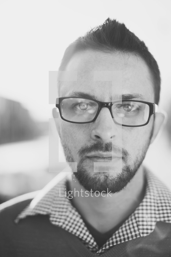 face of a man wearing reading glasses 