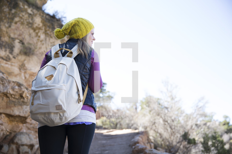 woman with a backpack on a trail 
