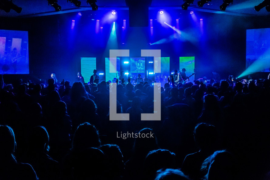 stage lights over an audience at a concert 