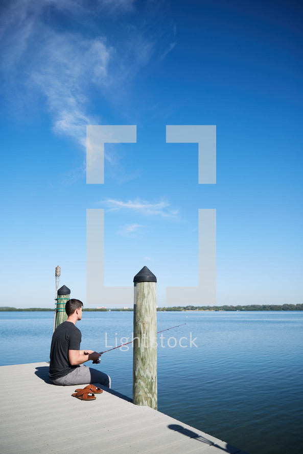 a man fishing on a pier 