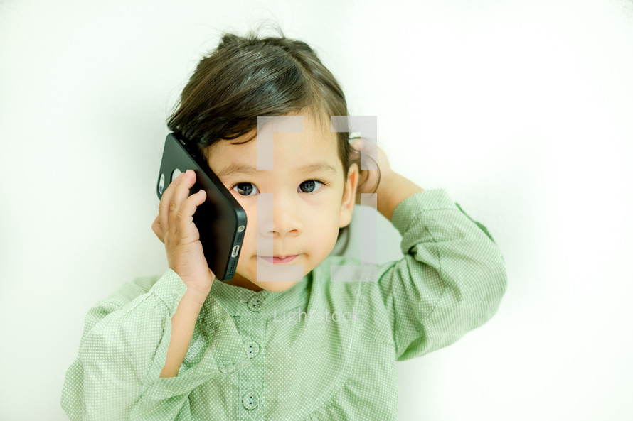 little girl talking on a cellphone 