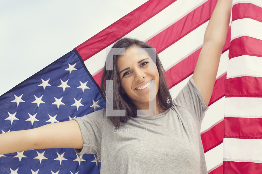 Young woman holding an American Flag 