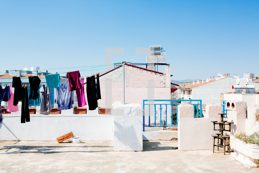 clothes hanging on a clothesline on a rooftop 