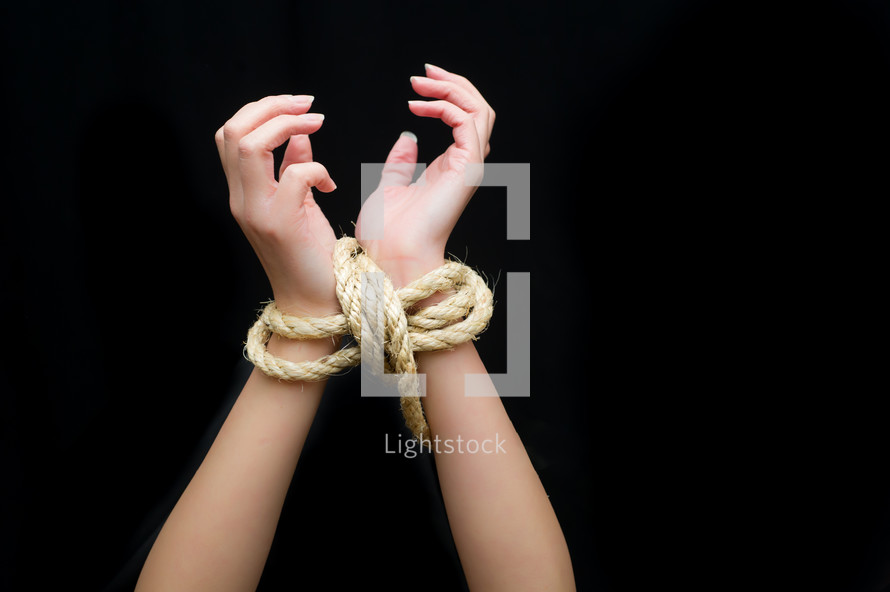A woman with tied wrists. 