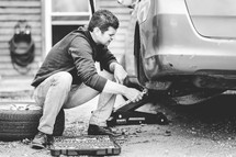 a man changing a tire 