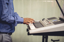 Man playing the electric piano in India.