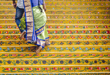 Woman walking up the steps of the Varaha Lakshmi Narasimha Hindu temple in India.
