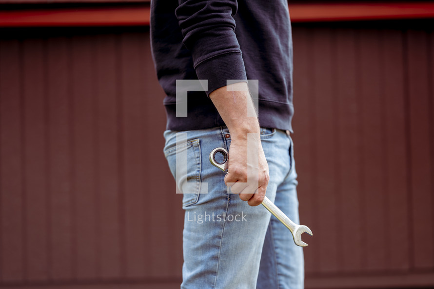 a man holding a wrench 