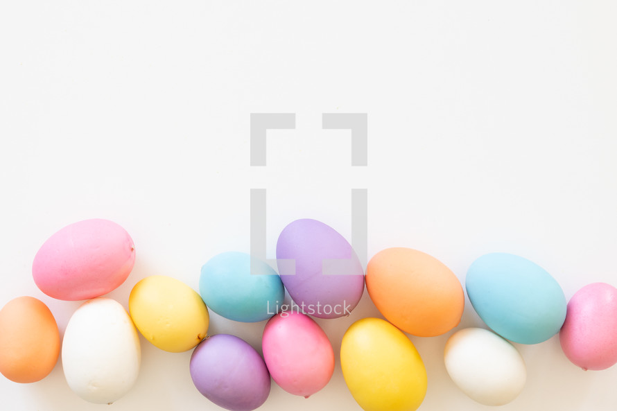 Border of easter eggs on a white background