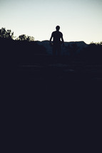 silhouette of a man walking outdoors