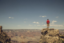 man standing looking out over the Grand Canyon