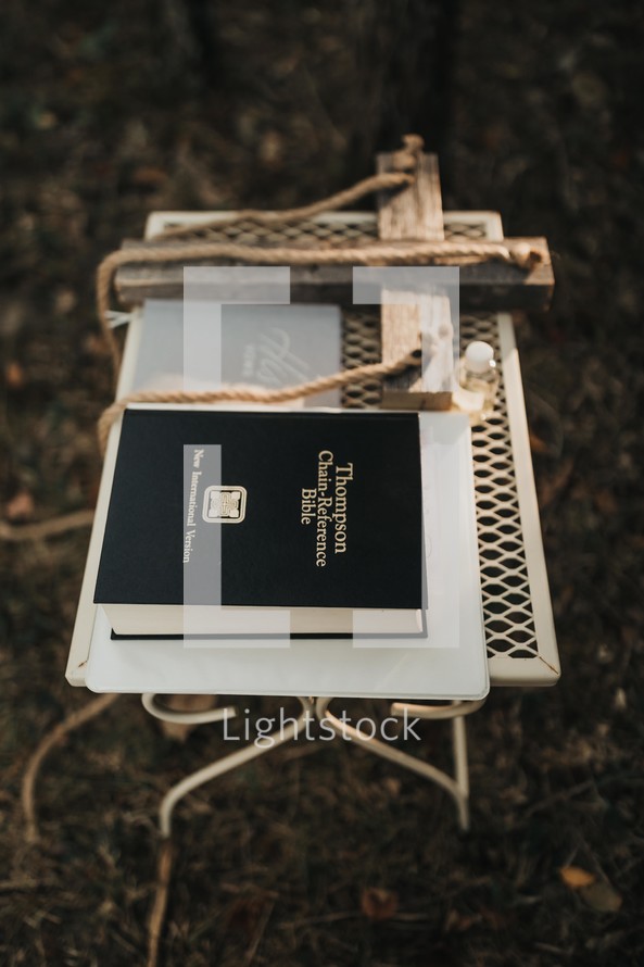 cross and Bible on a table at an outdoor wedding 