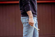 a man holding a wrench 