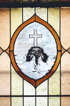 cross on a rock at sea stained glass window 