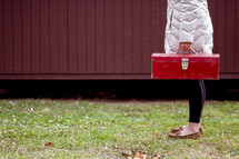 a woman holding a toolbox
