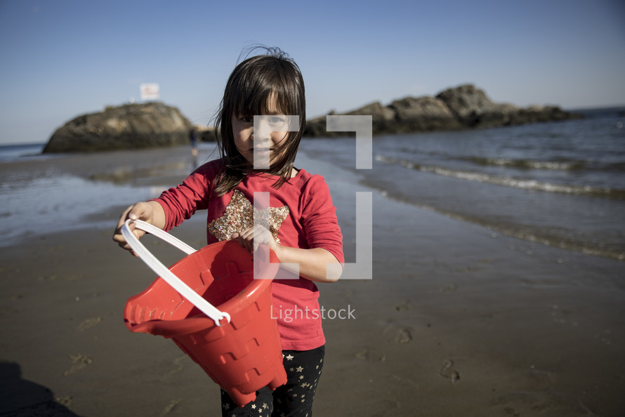 Little girl playing on the beach