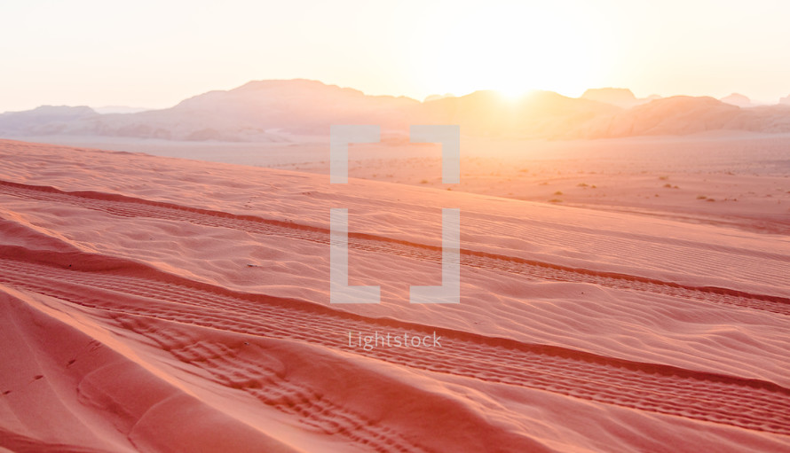 tracks in red desert sand in the Wadi Rum desert in Jordan