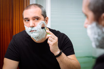 man shaves with a razor 