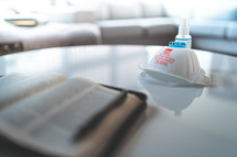 respirator mask and Bible on a table 