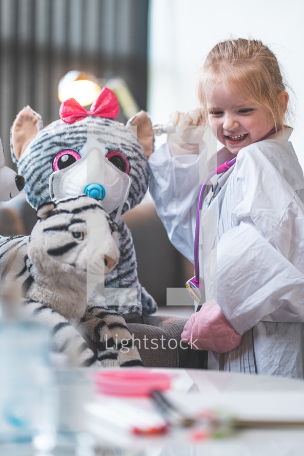 little girl pretending to be a doctor 