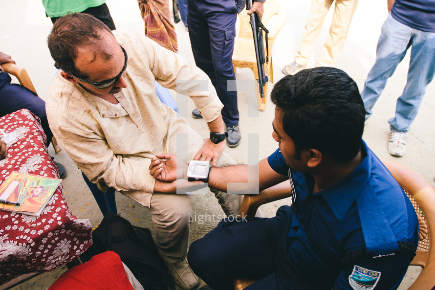 healthcare and medicine - man getting his blood pressure checked 